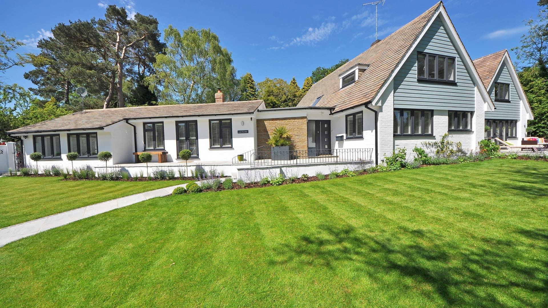 A freshly mowed, healthy green lawn in front of a well-kept home